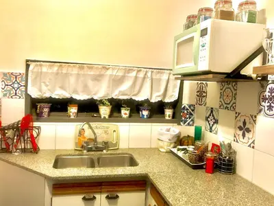 a kitchen with a sink and a microwave at apart Italia in Río Cuarto
