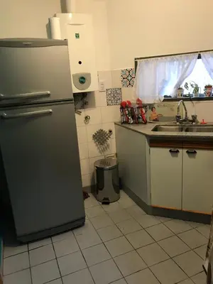 a kitchen with a refrigerator and a sink at apart Italia in Río Cuarto