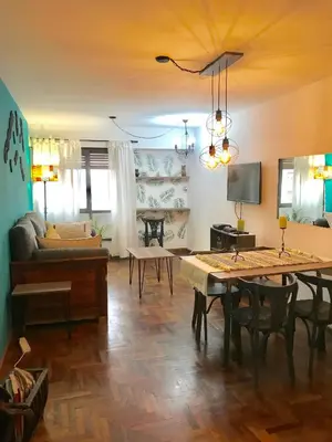 a living room with a table and a couch at apart Italia in Río Cuarto