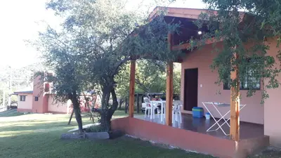 a view of a house with a patio at Cabañas Rosaditas in Santa Rosa de Calamuchita