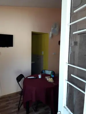 a room with a table with a purple table cloth at Santorini Bed en Córdoba in Cordoba