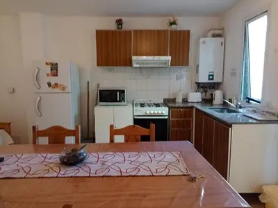 a kitchen with a table and a kitchen with a refrigerator at Apartamentos Santa Rosa 2 B T1 in Cordoba