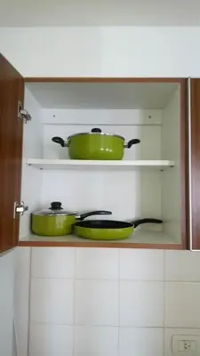 two pots and pans sitting on a shelf in a kitchen at Apartamentos Santa Rosa 2 B T1 in Cordoba