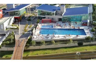 a large swimming pool with people sitting around it at alto villa sol in Cordoba