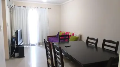 a dining room with a table and chairs and a television at alto villa sol in Cordoba