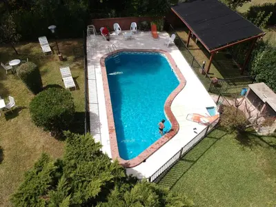 an overhead view of a swimming pool with a person in it at Hotel Samay Huasi in Villa General Belgrano