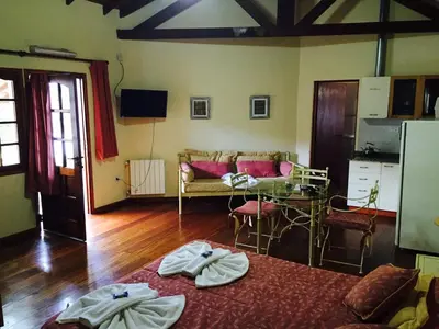 a living room with a couch and a table at Cabañas y Lofts El Portal in Villa General Belgrano