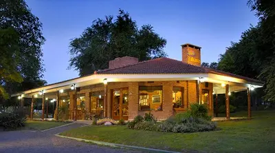 a house with lights on the front of it at Cabañas y Lofts El Portal in Villa General Belgrano