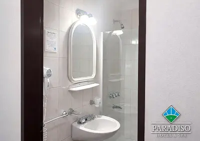 a bathroom with a sink and a mirror at Paradiso Hotel in Merlo