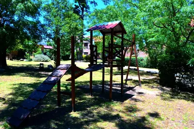 a park with a playground with a slide at Paradiso Hotel in Merlo