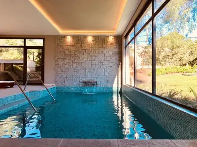 a swimming pool in the middle of a house at Paradiso Hotel in Merlo