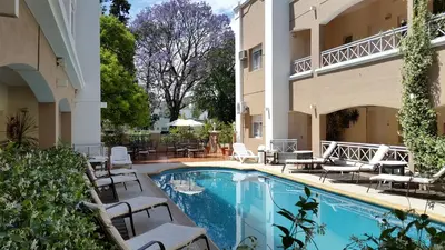 a swimming pool in front of a building at Solares Hotel & Spa in Alta Gracia