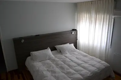a bed with two pillows on it in a bedroom at Solares Hotel & Spa in Alta Gracia