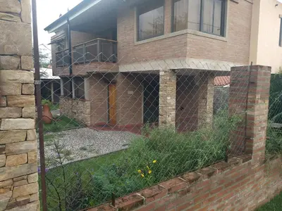a fence in front of a house at Los algarrobos in Villa Carlos Paz
