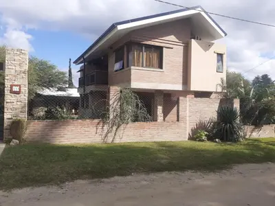 a brick house with a window on the side of it at Los algarrobos in Villa Carlos Paz