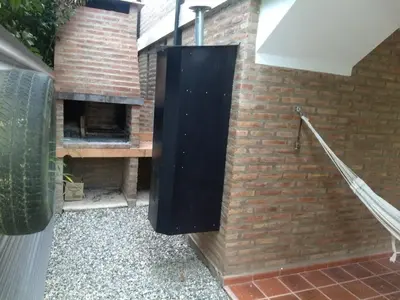 a brick wall with a pizza oven on it at Los algarrobos in Villa Carlos Paz