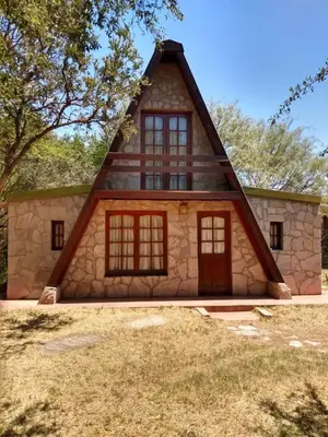 a small house with a gambrel roof at Cabaña Tío Miguel in Los Molles