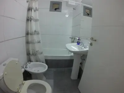 a bathroom with a toilet and a sink at Edificio Pampa - Departamento Nueva Córdoba in Cordoba