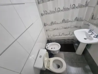 a bathroom with a toilet and a sink at Edificio Pampa - Departamento Nueva Córdoba in Cordoba
