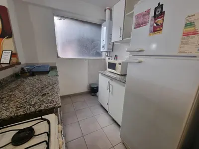 a kitchen with white appliances and a white refrigerator at Edificio Pampa - Departamento Nueva Córdoba in Cordoba