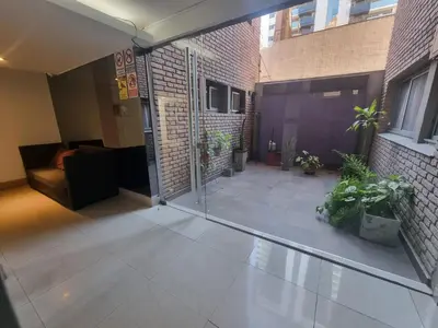 an empty courtyard with a glass door in a building at Edificio Pampa - Departamento Nueva Córdoba in Cordoba