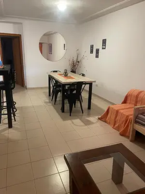 a living room with a table and a couch at Alonso 540 Departamento in Río Cuarto