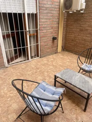a patio with two chairs and a table at Alonso 540 Departamento in Río Cuarto
