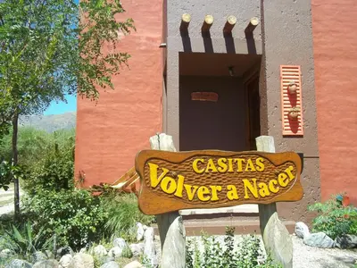 a sign in front of a building that says casitas wavers over a niece at Casitas Volver a Nacer in Carpintería