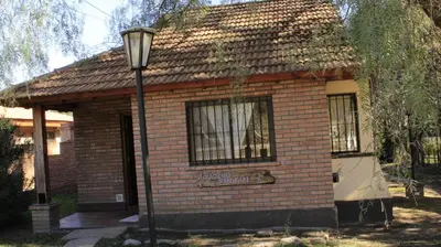 a small brick house with a street light in front of it at La sacha sin fin in Merlo