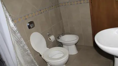 a bathroom with a toilet and a sink at La sacha sin fin in Merlo