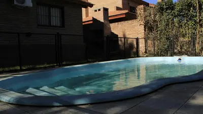 a swimming pool in a yard with a house at La sacha sin fin in Merlo