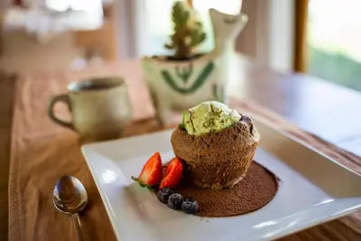 a piece of bread with ice cream and strawberries on a plate at Las Dalias in Villa de Las Rosas