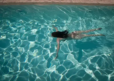 a woman floating in a pool of water at Las Dalias in Villa de Las Rosas