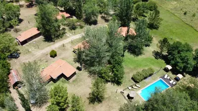 an overhead view of a house and a swimming pool at El Camino Viejo Cabañas in Villa General Belgrano
