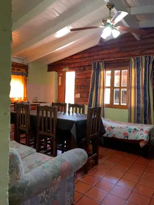 a dining room with a table and chairs at El Camino Viejo Cabañas in Villa General Belgrano