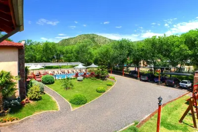 an aerial view of a resort with a swimming pool at Apart Hotel Las Palmeras in Villa General Belgrano