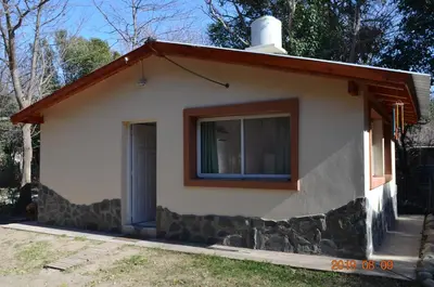 a small house with a window and a door at Alquimia Cabañas in San Francisco del Monte de Oro