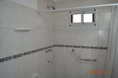 a bathroom with a shower and a window at Alquimia Cabañas in San Francisco del Monte de Oro