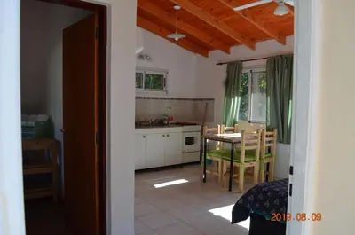 a kitchen and dining room with a table and chairs at Alquimia Cabañas in San Francisco del Monte de Oro