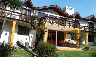 a house with yellow and white at Posada Shemak in Villa General Belgrano
