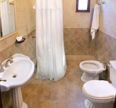 a bathroom with a sink and a toilet and a shower at Posada Shemak in Villa General Belgrano