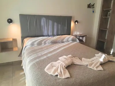 a bed with two towels on top of it at Casablanca Hotel & Spa in Santa Rosa de Calamuchita
