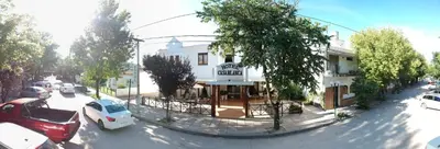 a view of a street with cars parked in front of a building at Casablanca Hotel & Spa in Santa Rosa de Calamuchita