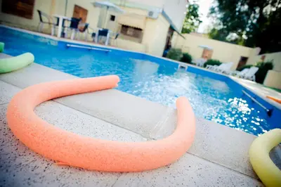 a swimming pool with an orange swim ring in front of it at Casablanca Hotel & Spa in Santa Rosa de Calamuchita