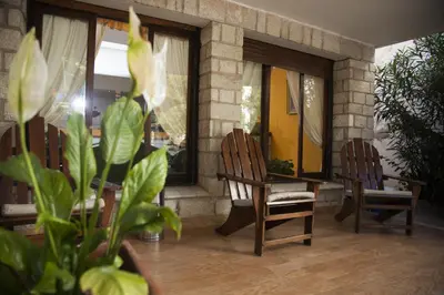 a room with two chairs and a table and windows at Casablanca Hotel & Spa in Santa Rosa de Calamuchita