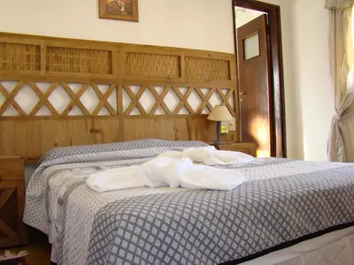 a bedroom with a bed with white towels on it at Casablanca Hotel & Spa in Santa Rosa de Calamuchita