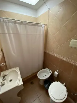 a bathroom with a sink and a toilet and a shower at Hotel Gloria in Santa Rosa de Calamuchita