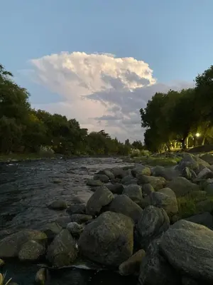 a river with large rocks in the water at Hotel Gloria in Santa Rosa de Calamuchita