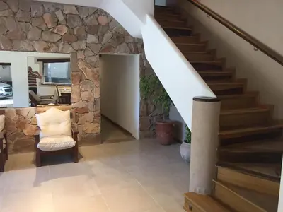 a staircase in a home with a stone wall at Hotel Gloria in Santa Rosa de Calamuchita
