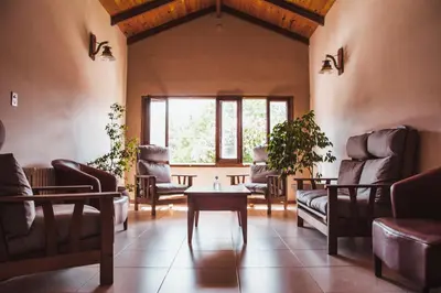 a living room with couches and a table at Hotel Gloria in Santa Rosa de Calamuchita